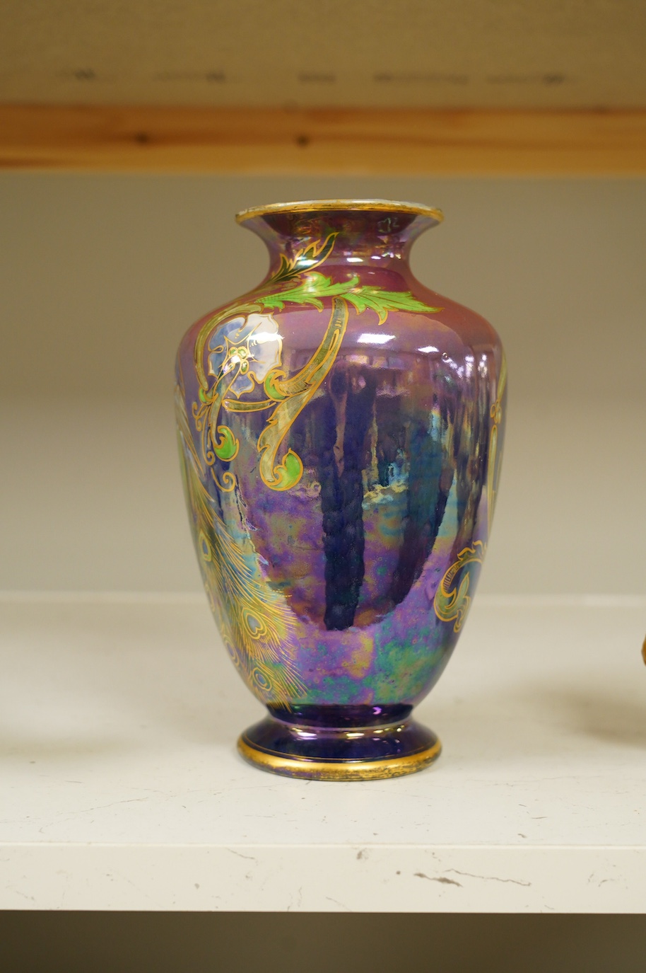 A Shelley Walter Slater pink and blue lustre peacock design vase, signed, 22cm high. Condition - fair to good, some wear to the gilt on the rim